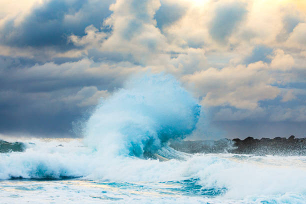 Colliding waves creating a unique water formation in nature with golden light. Shot along the South Coast of NSW, Australia.