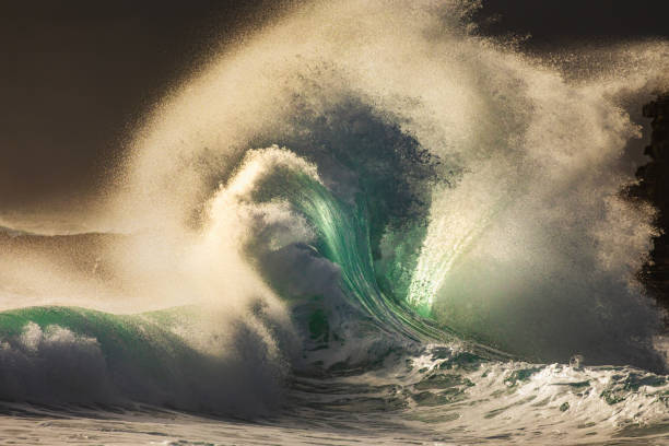 istock Colliding waves creating a dramatic display of power in nature with golden light 2154556129