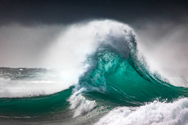 istock Colliding waves creating a dramatic display of power in nature with golden light 2154556179