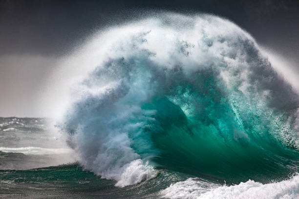 istock Colliding waves creating a dramatic display of power in nature with golden light 2154556200