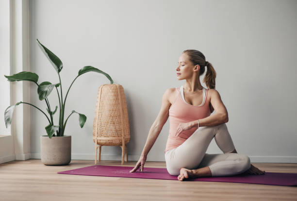 istock Woman practicing yoga, doing relaxation exercises, meditating at home 2154557490
