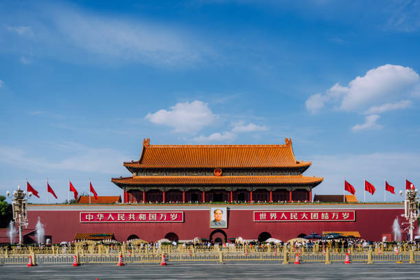 Editorial photo of Tiananmen Square, Beijing, China, taken on October 10, 2023. The iconic landmark features red flags and traditional Chinese architecture under a bright sky.