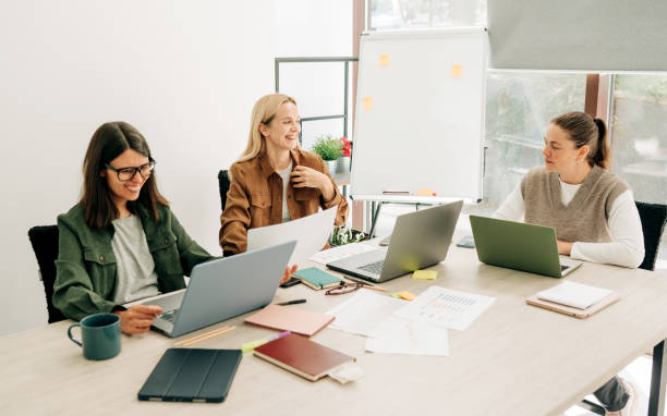 istock Young women using laptops working in the office, brainstorming and discussing business strategy. 2154561353