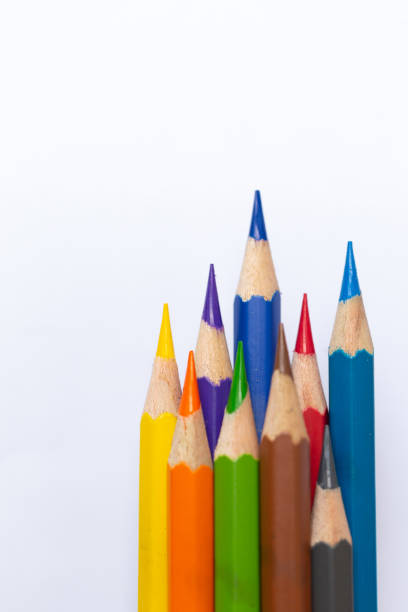 Vertical macro image of colored pencils The pointed tip is clearly visible isolated on a white background.