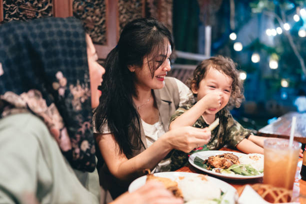 istock multiracial three generations family having dinner together outdoors in the restaurant 2154563889