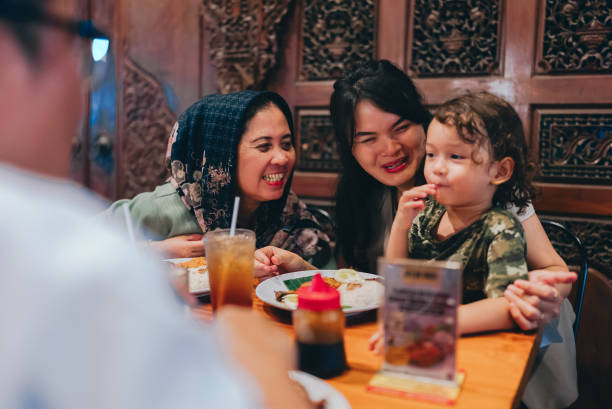 istock multiracial three generations family having dinner together outdoors in the restaurant 2154563894
