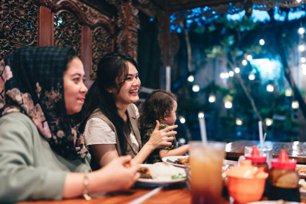istock multiracial three generations family having dinner together outdoors in the restaurant 2154563909