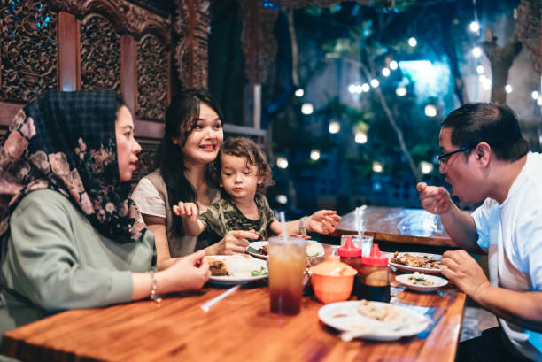 istock multiracial three generations family having dinner together outdoors in the restaurant 2154563912