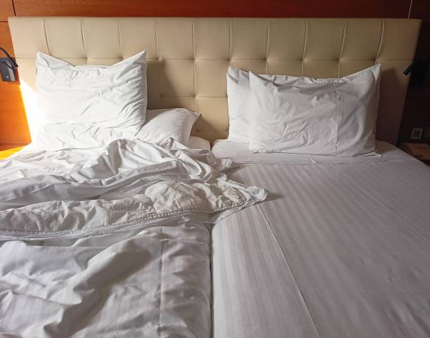 This time I am traveling alone. Double bed in a hotel. Half undone.