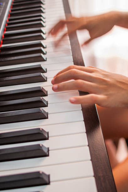 Young Girl Practicing on an Electronic Keyboard, Spain,