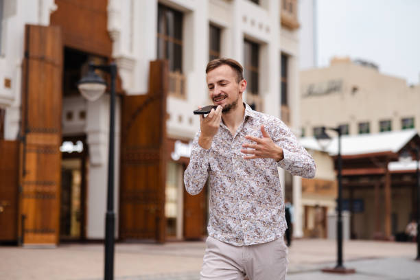 istock Young man talking on the phone while walking around the city square 2154567639