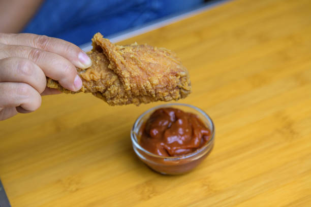 istock Hand holding a crispy fried chicken. Fast food 2154567652