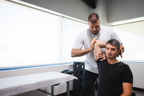 istock Young man getting stretched by a professional masseur 2154569455