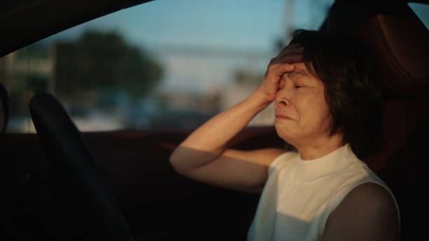 mature woman sad in car. - gangguan emosi dan mental potret stok, foto, & gambar bebas royalti