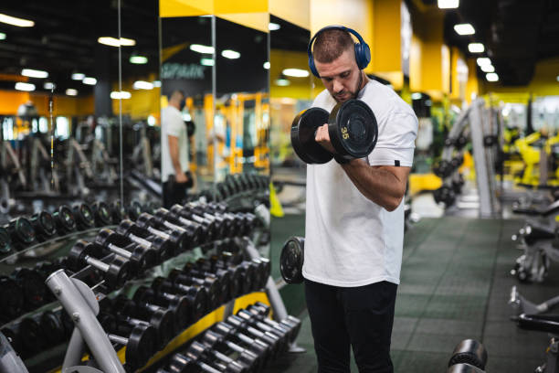 istock Young man lifting heavy weights at the gym 2154569909