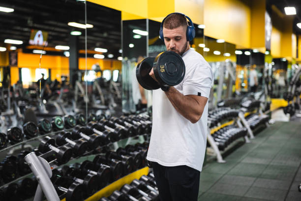 istock Young man lifting heavy weights at the gym 2154569936