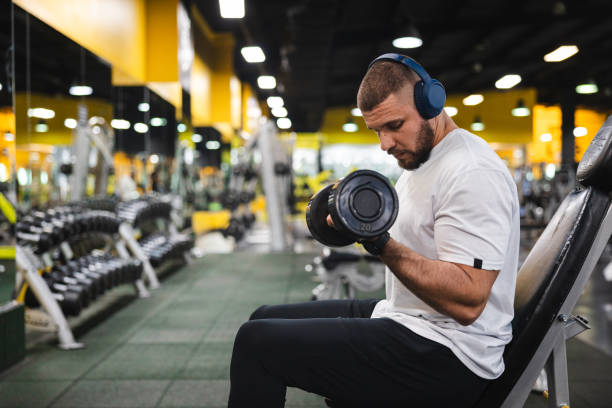 istock Young man lifting heavy weights at the gym 2154569988