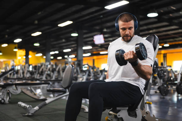 istock Young man lifting heavy weights at the gym 2154569989