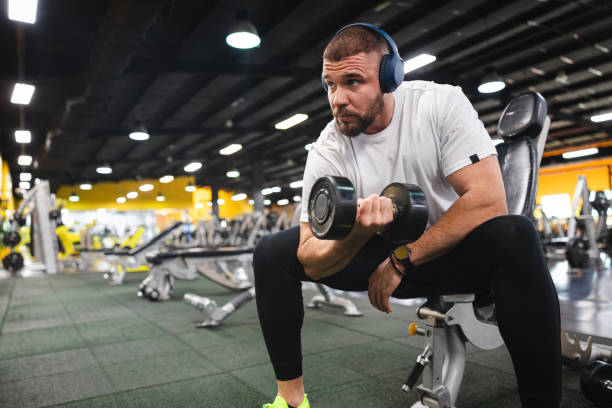 istock Young man lifting heavy weights at the gym 2154569999