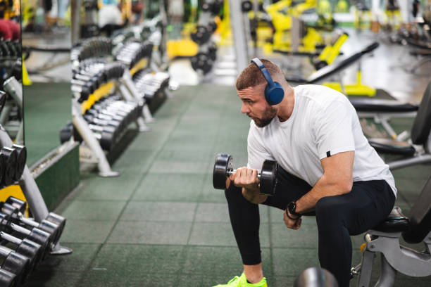 istock Young man lifting heavy weights at the gym 2154570003