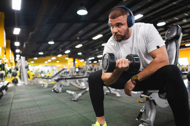 istock Young man lifting heavy weights at the gym 2154570005