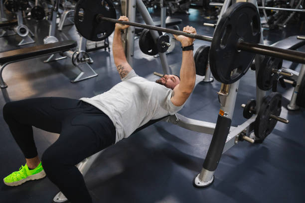 istock Young man lifting heavy weights at the gym 2154570063