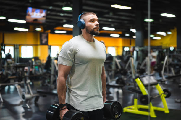 istock Young man lifting heavy weights at the gym 2154570948