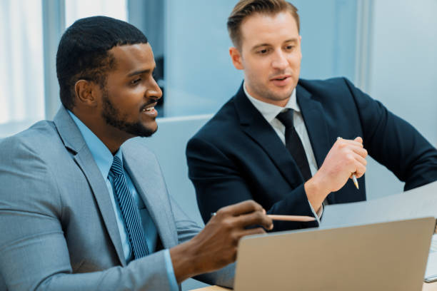 istock African male leader explain strategy while show solution to manager. Ornamented. 2154573982