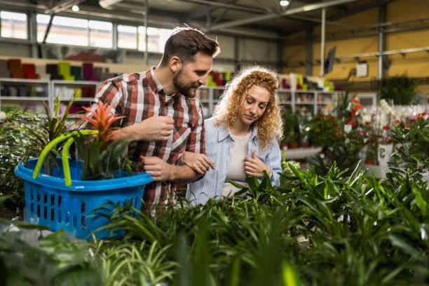 istock Happy Couple Shopping for Potted Plants 2154580206