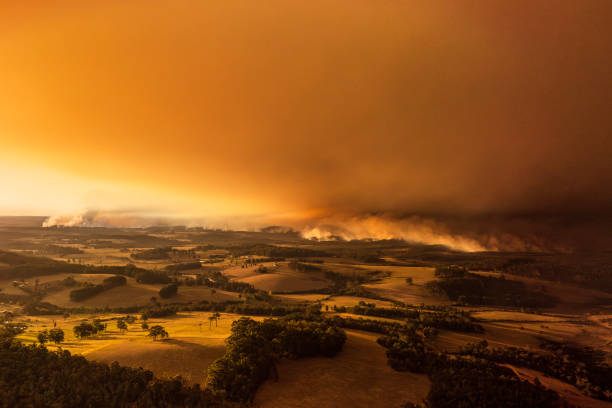 istock Thick smoke cloud over farmlands from out of control bush fire with dramatic golden light 2154581771