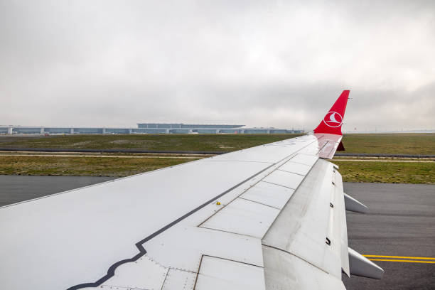 Istanbul Havalimani, Türkiye - February 26th 2024:  View to the airport building during take off with a Boeing 737 Max 9 from Turkish Airlines in the flat landscape