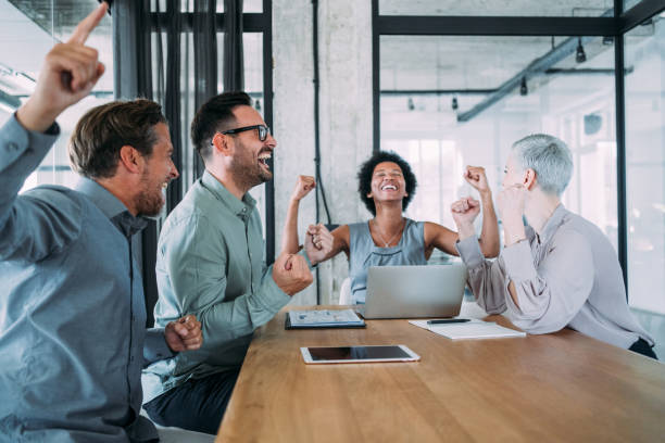 istock Cheerful entrepreneurs celebrating success in the office. 2154584892
