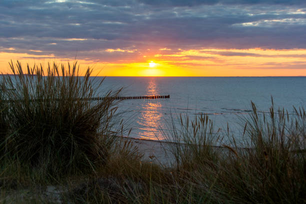 istock Sunset over the sea, with sand dunes and beach grass 2154587004
