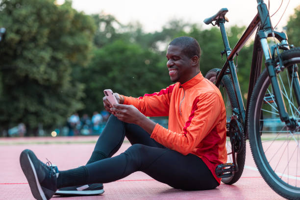istock Cyclist taking a break to check his phone outdoors 2154587834
