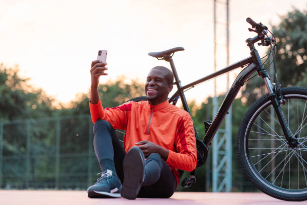 istock Man relaxing with bicycle taking selfie outdoors 2154587858