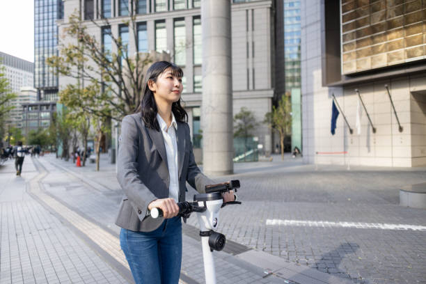 istock Young businesswoman commuting by e-scooter in city 2154587985