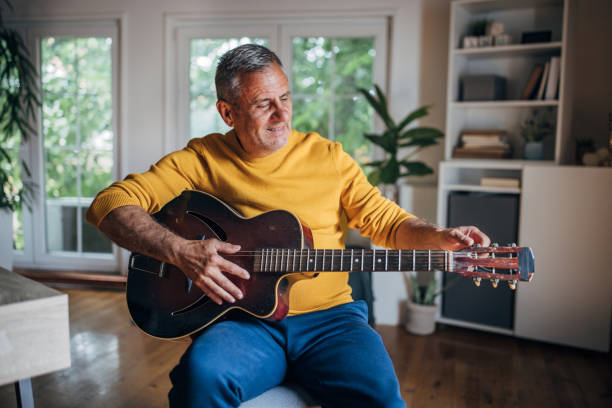 istock Senior man enjoying music time with guitar 2154588026