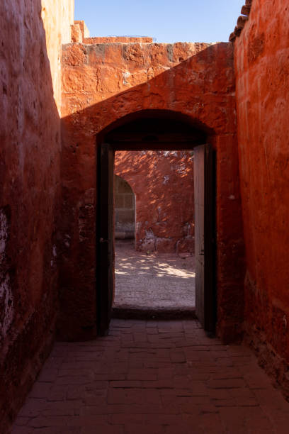 istock A narrow, dark hallway with a doorway in the middle 2154592827