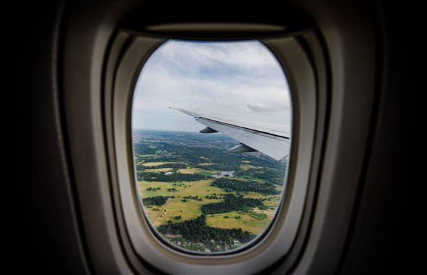 istock the serene beauty from an airplane window, featuring the wing silhouetted against an expansive, cloud-filled sky, instilling a sense of height and peacefulness. 2154600539