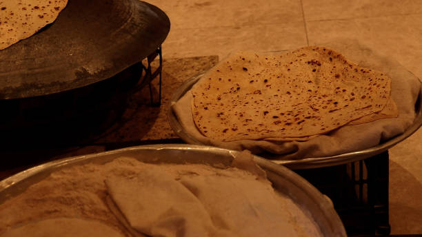 A freshly baked Jordanian shrak bread on a metal serving tray. Shrak bread is a type of flatbread widely popular in Levantine countries like is Lebanon, Jordan, Palestine and Syria. shrak stock pictures, royalty-free photos & images