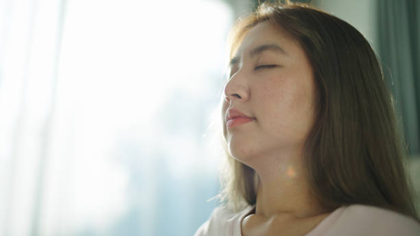 istock Asian woman meditating on mat at home. 2154608687