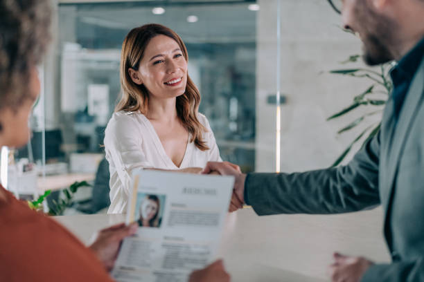 Successfully passed job interview. Shot of recruiter shaking hands with a female candidate after a job interview. HR manager handshaking female candidate congratulating with hiring. good cv stock pictures, royalty-free photos & images
