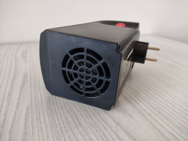 istock Black electric mini air heater for room. Socket plug is located on the device body. 2154611034