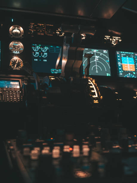 istock Cockpit view of an airplane during a night-time flight with illuminated instrument panels 2154612087