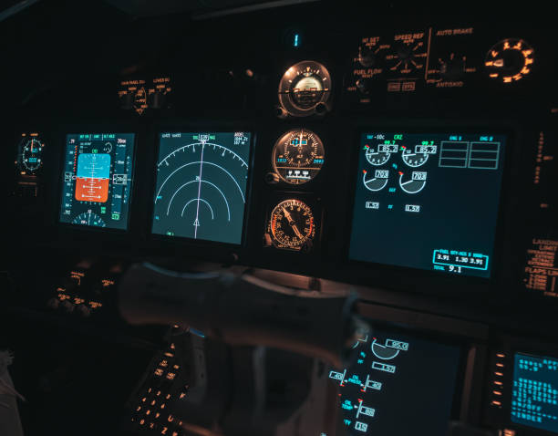 istock Cockpit view of an airplane during a night-time flight with illuminated instrument panels 2154612337