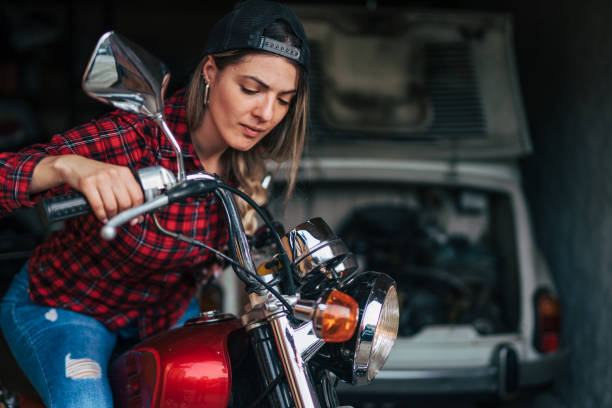 istock young woman repair old timer motorcycle 2154612476