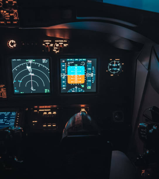 istock Cockpit view of an airplane during a night-time flight with illuminated instrument panels 2154612501