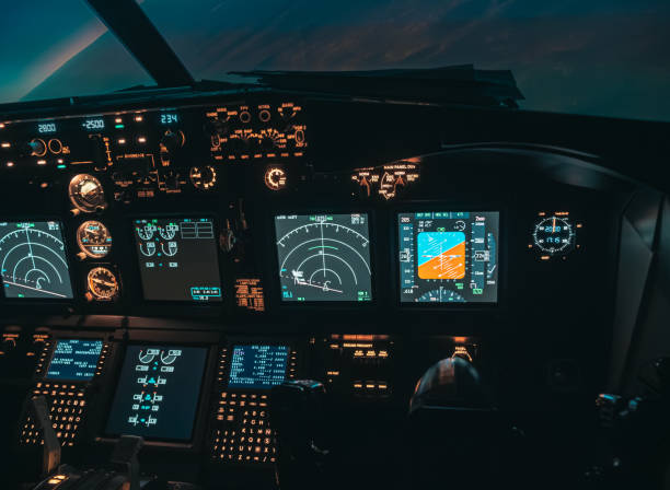 istock Cockpit view of an airplane during a night-time flight with illuminated instrument panels 2154612676