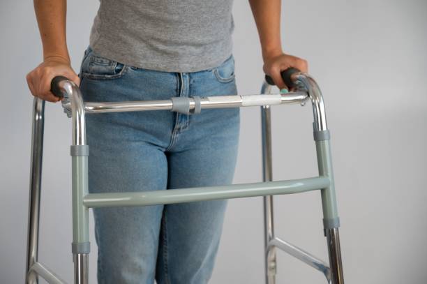 istock A woman is walking with a walker on a white background 2154612862