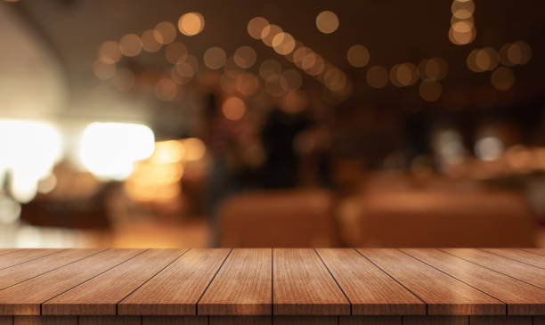 istock Empty wooden table top with lights bokeh on blur restaurant background. 2154613086